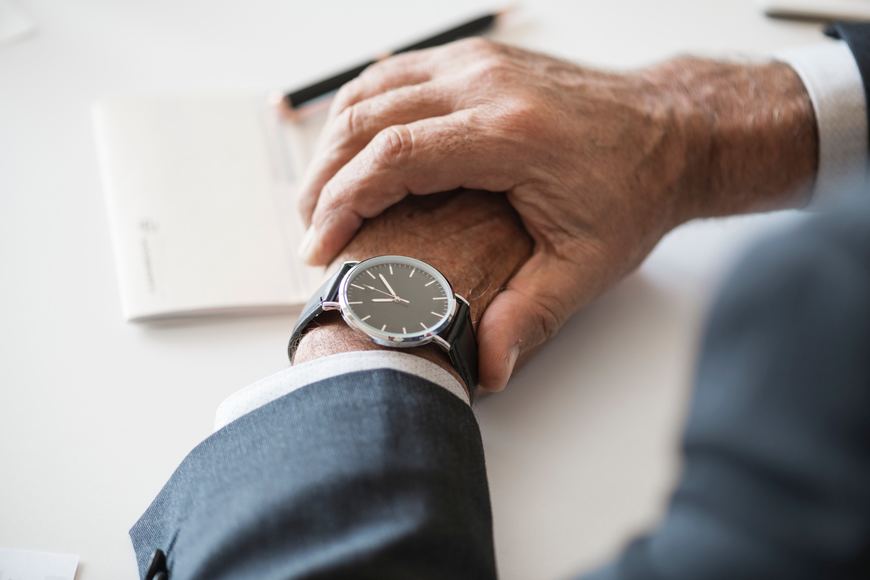 A person impatiently checking their watch.